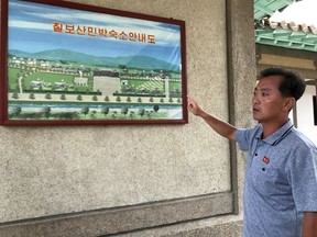 In this Aug. 20, 2018, photo, North Korea official So Myong Il introduces the layout of homestay lodgings in Mount Chilbo, North Korea. Mount Chilbo, one of the country's most cherished natural attractions, is gearing up for a future it hopes will include a lot of economic development.