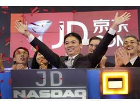 FILE - In this file photo taken Thursday, May 22, 2014, Liu Qiangdong, also known as Richard Liu, CEO of JD.com, raises his arms to celebrate the IPO for his company at the Nasdaq MarketSite, in New York. JD.com, China's No. 2 e-commerce service, is headquartered in Beijing. The Chinese e-commerce billionaire who faces a possible rape accusation in Minneapolis built his business by promising honesty in a market plagued by fraud and fakes.