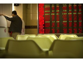 A Chinese investor uses a computer terminal to monitor stock prices at a brokerage house in Beijing Friday, Sept. 28, 2018. Asian markets rebounded on Friday as strong U.S. economic data supported the Federal Reserve's decision to raise interest rates.