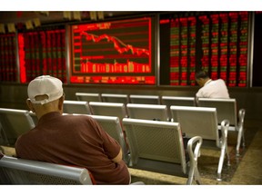 Chinese investors monitor stock prices at a brokerage house in Beijing, Tuesday, Sept. 11, 2018. Asian stocks were mixed Tuesday after Wall Street's gains as investors waited for a new U.S. tariff hike in a trade battle with China.