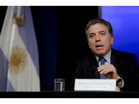 Argentina's Treasury Minister Nicolas Dujovne gives a news conference in Buenos Aires, Argentina Monday, Sept. 3, 2018. Argentina's President Mauricio Macri announced a withholding tax on exports and the elimination of several ministries amid economic turmoil that has sent the peso to record lows.