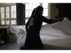 In this Thursday, Sept. 20, 2018 photo, a cleaning lady works in an apartment located on Airbnb in Paris. The spectacular growth of Airbnb in Paris, the top worldwide location for the internet giant is also raising alarms in the French capital. Some Parisians and officials at City Hall blame the site for driving Parisian families out of the city center, leading to school closures and concerns that the French capital is losing its life and charms.