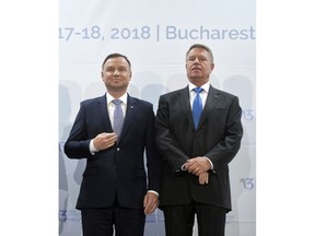 Polish President Andrzej Duda, left, poses next to Romanian counterpart Klaus Iohannis at the opening of the Three Seas Initiative in Bucharest, Romania, Monday, Sept. 17, 2018. U.S. President Donald Trump has reaffirmed Washington's support for a business summit that aims to boost connectivity in Eastern Europe and improve ties between the region and the U.S. and European Union.