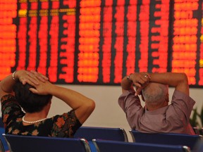 Investors in China observe stock market data.