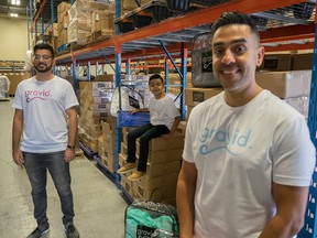 Gravid co-founders Omar Shahban, left, and Fahd Javed, right, and son Azmir Javed, 7, in their warehouse in Mississauga, Ont.
