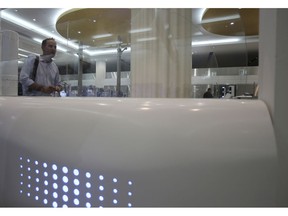 A passenger walks through the Smart Tunnel at the airport in Dubai, United Arab Emirates, Wednesday, Oct. 10, 2018. Passport control looked a little different today in Dubai at the world's busiest airport for international travel. That's because Dubai International Airport debuted a new "smart tunnel."