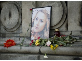 The photo of Viktoria Marinova, the journalist who was raped and strangled on Saturday, is placed on the Liberty Monument in Ruse, Bulgaria, Wednesday, Oct. 10, 2018. German police have arrested a suspect in the rape and killing of a television journalist from Bulgaria whose work highlighted corruption in the East European country.