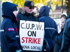 Canadian Union of Postal Workers (CUPW) members stand on picket line in Halifax on Monday after a call for a series of rotating 24-hour strikes.