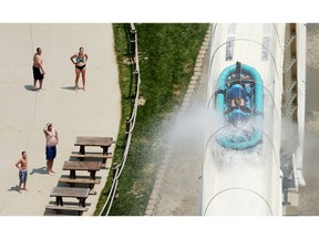 FILE - In this July 9, 2014, file photo, riders are propelled by jets of water as they go over a hump while riding a water slide called "Verruckt" at Schlitterbahn Water Park in Kansas City, Kan. Testimony has concluded in the trial of two maintenance workers at the water park who are accused of deliberately misleading investigators after a 10-year-old boy was decapitated on the waterslide. Deliberations will begin Thursday, Oct. 18, 2018 after closing arguments are made in the case against David Hughes and John Zalsman.