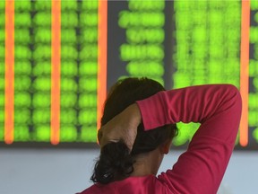 A investor monitors stock prices at a securities company in Hangzhou in China's eastern Zhejiang province on October 18, 2018.