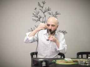 Justin Loizos, owner of the Just Compassion marijuana dispensary in Toronto, uses marijuana to help alleviate pain on Monday, October 15, 2018.