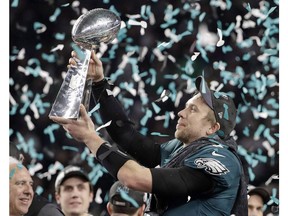 Philadelphia Eagles' Nick Foles holds up the Vince Lombardi Trophy after the NFL Super Bowl 52 football game against the New England Patriots, Sunday, Feb. 4, 2018, in Minneapolis. Will Canadian fans of big-budget, American Super Bowl ads get to see them while the NFL championship game is played next February, or will that be ruled out of bounds after just two seasons?