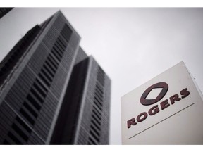 A Rogers Communications Inc. logo is shown outside the Rogers Building in Toronto on Tuesday, April 22, 2014.  Rogers Communications Inc. says it had a net income of $594 million in the third quarter for a 17 per cent increase from the same quarter last year as it boosted its full-year outlook.