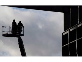 Workers are pictured at the Vancouver Shipyard in an October 7, 2013, file photo. Statistics Canada says the country gained 63,000 jobs in September, edging the unemployment rate lower to 5.9 per cent.