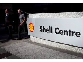 Pedestrians walk past Shell Canada's headquarters during a news conference in Calgary, Thursday, Aug. 26, 2010. Royal Dutch Shell's name is being removed from a tiny 65-year-old employee credit union as its visibility in the Alberta oil and gas industry continues to shrink in the wake of the sale of most of its oilsands assets last year.