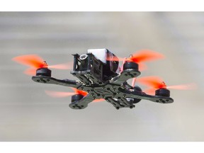 A drone hovers over the course during the Montreal drone expo, Saturday, June 25, 2016.