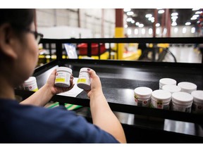 A worker examines cannabis products at the Ontario Cannabis Store distribution centre in an undated handout photo.