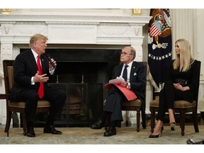 Ivanka Trump, right, and White House chief economic adviser Larry Kudlow, center, listen as President Donald Trump speaks during the "Our Pledge to America's Workers" event in the State Dining Room of the White House, Wednesday, Oct. 31, 2018, in Washington.