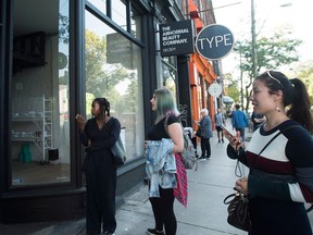 People react as they look outside the beauty supply store Deciem as it has closed all locations unexpectedly in Toronto on Tuesday, October 9.