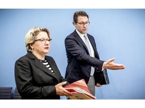 German Transportation Minister Andreas Scheuer, right, and German Environment Minister Svenja Schulze, left, arrive for a news conference in Berlin, Wednesday, Oct. 2, 2018.