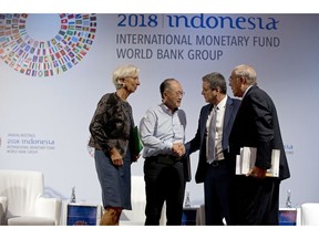 World Bank President Jim Yong Kim, second left, greets Director General of the World Trade Organization Roberto Azevedo, second right, Managing Director of International Monetary Fund (IMF) Christine Lagarde, left, and Secretary General of the Organization for Economic Co-operation and Development Angel Gurria during a trade conference in Bali, Indonesia Wednesday, Oct. 10, 2018.