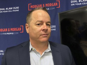 Shawn Hudson stands in his lawyers office after filing a lawsuit against Tesla on Tuesday, Oct. 30 in Orlando, Fla. The lawsuit says the autopilot feature of his Tesla Model S failed to detect a disabled car on a highway, leading to a collision that left him with permanent injuries.