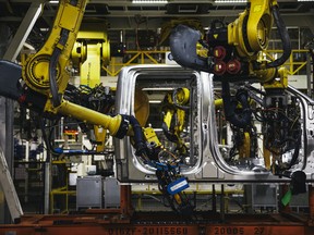 Robotic arms attach rivets to the frame of a truck at the Ford Motor Co. Dearborn Truck Plant in Dearborn, Michigan.