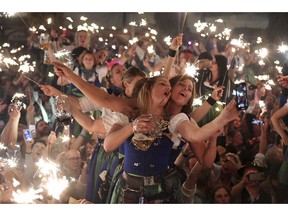 In this Oct. 7, 2018 photo waitress dance in the Hofbraeu tent after the closing of the Oktoberfest beer festival in Munich, southern Germany, which ran from Sept. 22 through Oct. 7, 2018.