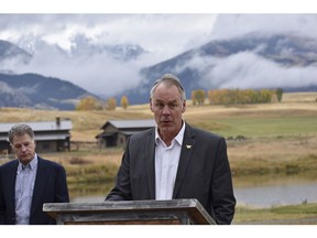 In this Oct. 8, 2018 photo, U.S. Interior Secretary Ryan Zinke announces a ban on mining claims north of Yellowstone National Park as K.C. Walsh, left, president of Simms Fishing Products, listens near Emigrant, Mont. The Trump administration is considering using West Coast military bases or other federal properties as transit points for shipments of U.S. coal and natural gas to Asia as officials seek to bolster the domestic energy industry and circumvent environmental opposition to fossil fuel exports, according to Zinke and two Republican lawmakers.