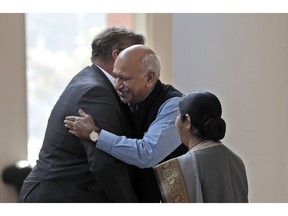 FILE - In this Nov. 24, 2017 file photo, Indian Junior Foreign Minister M.J. Akbar, center, hugs Finland's Foreign Minister Timo Soini in New Delhi, India. Akbar has resigned amid accusations by at least 15 women of sexual harassment during his previous career as a news editor.