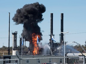Flame and smoke erupts from the Irving Oil refinery in Saint John, N.B., on Monday.