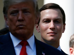 White House senior adviser Jared Kushner, right, stands behind President Donald Trump, left, during a news conference as he announces a revamped North American free trade deal, in the Rose Garden of the White House in Washington, Monday, Oct. 1, 2018.