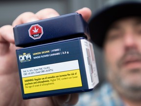 A customer shows off his cannabis purchase outside British Columbia's first legal B.C. cannabis store in Kamloops, B.C.