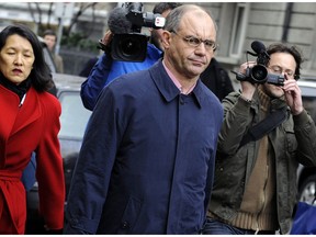 FILE - In this Wednesday, Jan. 19, 2011 file photo, Swiss banker Rudolf Elmer leaves a Zurich District Court where he faced charges of coercion and breaking Switzerland's strict bank secrecy laws, in Zurich, Switzerland. Switzerland's high court has upheld the acquittal of a former private banker who handed over confidential client information to WikiLeaks, ruling he wasn't bound by the country's strict banking secrecy laws at the time. The Federal Tribunal validated a ruling by Zurich's regional supreme court in the case of Rudolf Elmer, a former top accountant at a Cayman Islands affiliate of Swiss bank Julius Baer who was fired in 2002.