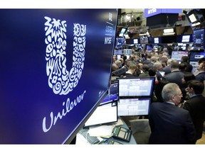 FILE - In this Thursday, March 15, 2018 file photo, the logo for Unilever appears above a trading post on the floor of the New York Stock Exchange. Anglo-Dutch consumer goods multinational Unilever, whose brands include Knorr and Dove, has scrapped a plan to consolidate its headquarters in the Netherlands following opposition from British shareholders. The company, which has head offices in both Rotterdam and London, says in a statement Friday, Oct. 5, 2018 that the plan to make Rotterdam its sole headquarters "has not received support from a significant group of shareholders."
