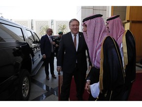 U.S. Secretary of State Mike Pompeo, center, walks with Saudi Foreign Minister Adel al-Jubeir in Riyadh, Saudi Arabia, Tuesday Oct. 16, 2018. U.S. Secretary of State Mike Pompeo met on Tuesday with Saudi Arabia's King Salman over the disappearance and alleged slaying of Saudi writer Jamal Khashoggi, who vanished two weeks ago during a visit to the Saudi Consulate in Istanbul.