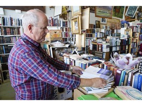 At a second-hand bookstore Thorvaldur Mariuson displays the former best-selling government report, known locally as "The Report",  analysing the reasons for Iceland's enormous bank crash, in Reykjavik, Iceland, Sunday Oct. 7, 2018.  On the 10-year anniversary of the financial crash, now known as "hrunid", the collapse, the last in a series of prosecutions of those deemed responsible has started, and Icelanders look for some closure after years of reckoning and reconstruction.