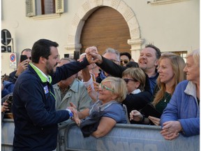 Italian Deputy Premier and League leader Matteo Salvini greets supporters during a rally in Mezzocorona, northern Italy, Friday, Oct. 19, 2018.