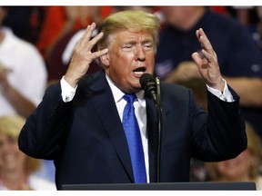 President Donald Trump gestures as he speaks at a rally Tuesday, Oct. 2, 2018, in Southaven, Miss.