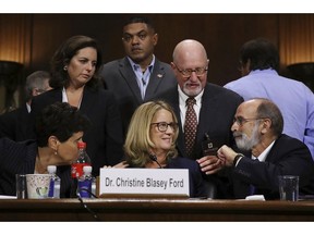Christine Blasey Ford and her attorneys Debra Katz, foreground left, and Michael Bromwich, foreground right, take a break during testimony before the Senate Judiciary Committee, Thursday, Sept. 27, 2018 in Washington.