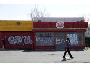 In this April 26, 2018, photo a man walks by a closed restaurant along Bergen Street in a so-called "opportunity zone" in Newark, N.J. The Trump administration on Friday, Oct. 19, proposed rules for investors in a new program that it says could have a big impact on economically depressed areas around the country. About 8,700 of the opportunity zones have been set up in all 50 states and to lure investors and developers with tax breaks.