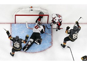 Vegas Golden Knights right wing Alex Tuch, right, celebrates after scoring against Ottawa Senators goaltender Craig Anderson (41) during overtime of an NHL hockey game, Sunday, Oct. 28, 2018, in Las Vegas.