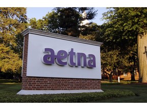 FILE - IN this June 1, 2017 file photo,. a sign stands on the campus of the Aetna headquarters in Hartford, Conn.  The Justice Department has agreed to Aetna's plan to sell its Medicare Part D prescription drug plan business for individuals to fellow insurer WellCare, resolving competition concerns. Aetna announced Sept. 2018 it'd sell the business for an undisclosed amount. The move was seen as a way for CVS Health to move forward with its $69 billion takeover of Aetna.