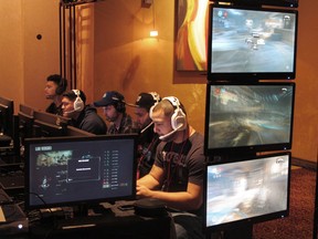FILE - In this March 31, 2017, file photo, video game players compete against one another in an esports tournament at Caesars casino in Atlantic City, N.J. Video gamers in the United States and elsewhere will soon be able to bet on themselves. The live-betting esports platform Unikrn had its wagering license approved by the Isle of Man on Tuesday, Oct. 23, 2018, clearing the way for users to legally gamble on competitive video games.