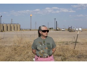 Suzanne Franklin stands near her home in Reeves County, West Texas, on April 11, 2018. Some mornings Franklin wakes with a nose full of dried blood, her voice filled with gravel. Her husband Jim suffers from respiratory problems, too. Complaints like hers are common among people who live near gas sites, academic research has found. Flares burning off gas spew pollutants that assault the respiratory system.