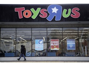 FILE - In this Jan. 24, 2018, file photo, a person walks near the entrance to a Toys R Us store, in Wayne, N.J. A group of investors is planning a potential comeback for Geoffrey the giraffe and his crew. Investors that control the assets of the company say they now see a better chance of a return on investment by potentially reviving the toy chain, rather than selling it off for parts.