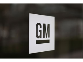 FILE - This Friday, May 16, 2014, file photo, shows the General Motors logo at the company's world headquarters in Detroit. General Motors and Honda are teaming up to create a self-driving vehicle.