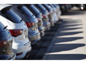 In this Oct. 21, 2018, photo a long line of unsold 2018 QX60 sports utility vehicles cast long shadows at an Infiniti dealership in Highlands Ranch, Colo. On Monday, Oct. 29, the Commerce Department issues its September report on consumer spending, which accounts for roughly 70 percent of U.S. economic activity.