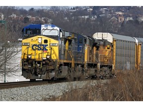 FILE- In this Feb. 12, 2018, file photo a CSX freight train passes through Homestead, Pa. CSX Corp. reports earnings Tuesday, Oct. 16.
