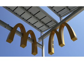 FILE- This Aug. 8, 2018, photo shows logos of McDonald's Chicago flagship restaurant. McDonald's Corp. reports earnings Tuesday, Oct. 23.